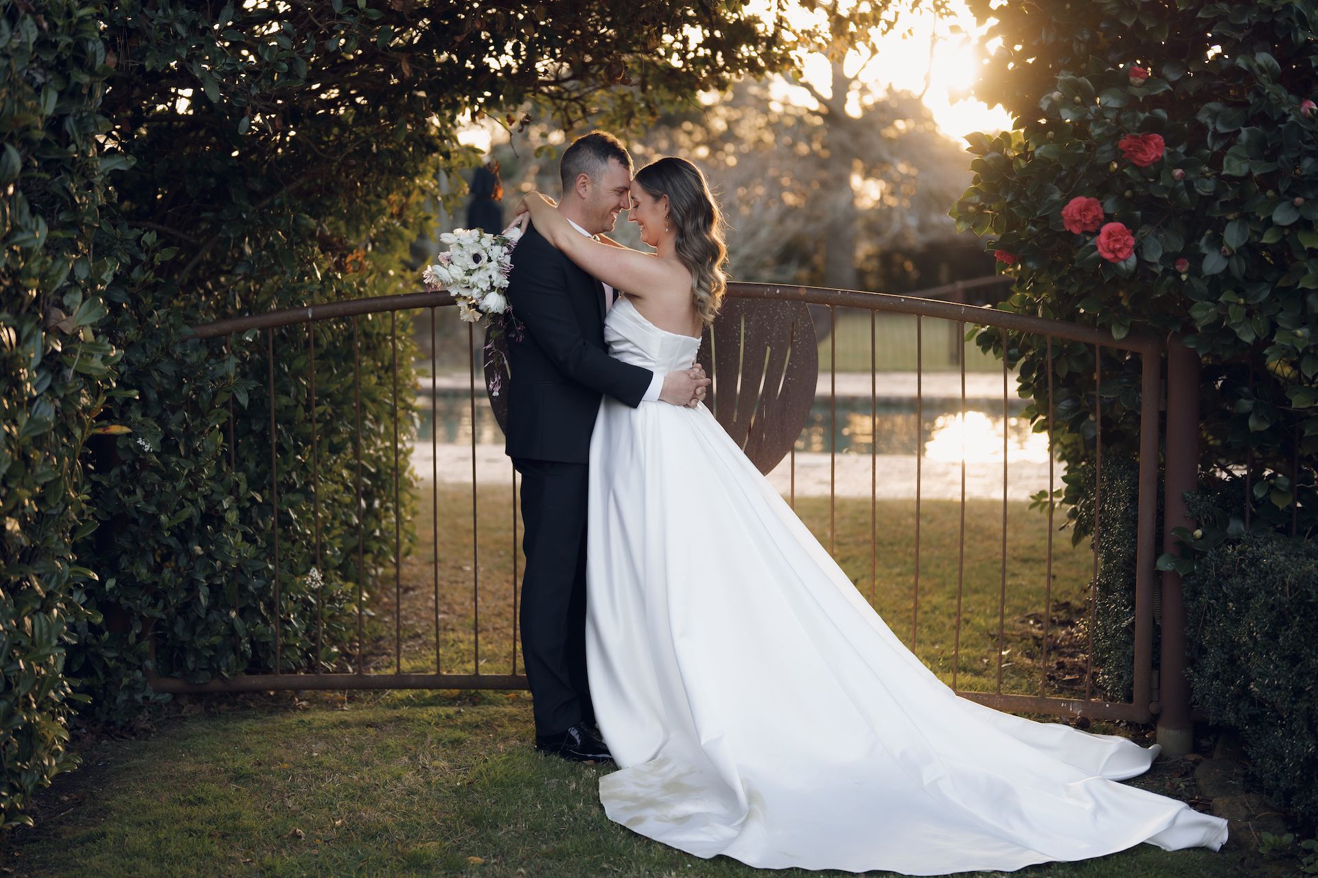 Newlyweds hugging and posing for a photo - raw footage wedding videography services in the Southern Highlands and surrounding areas - Just Footage